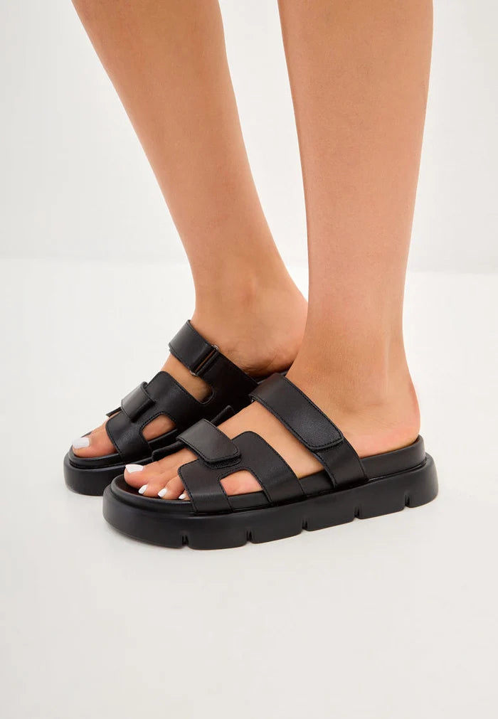 A stylish pair of black Kati platform mules, perfect for elevating any outfit with sophistication and flair.