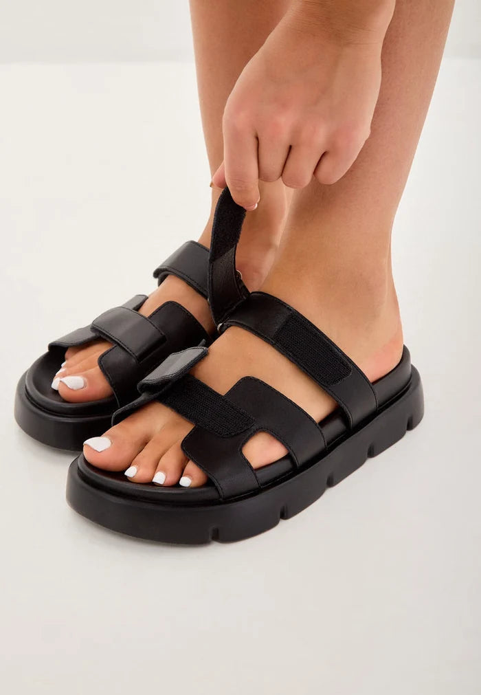 A stylish pair of black Kati platform mules with a sleek design and modern look.