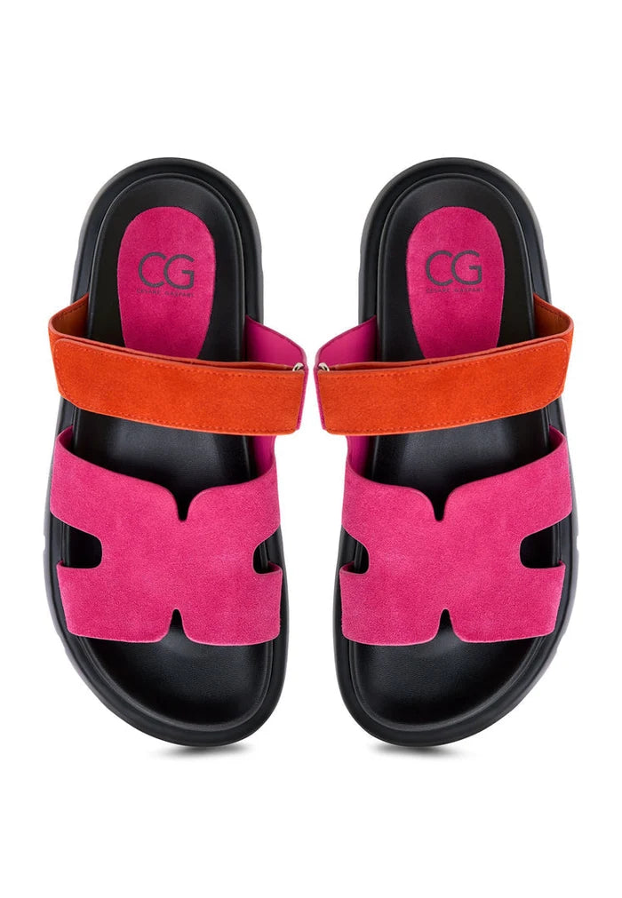 Chic and vibrant, these platform mules feature a striking kati pink suede finish with bold orange straps. Perfect for adding a pop of color to your outfit, these pink platform mules are a must-have fashion accessory.