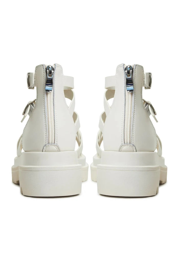 A close-up image of trendy white platform sandals, the Tatiana platform sandals, for women, featuring a stylish wedge heel and strappy design.