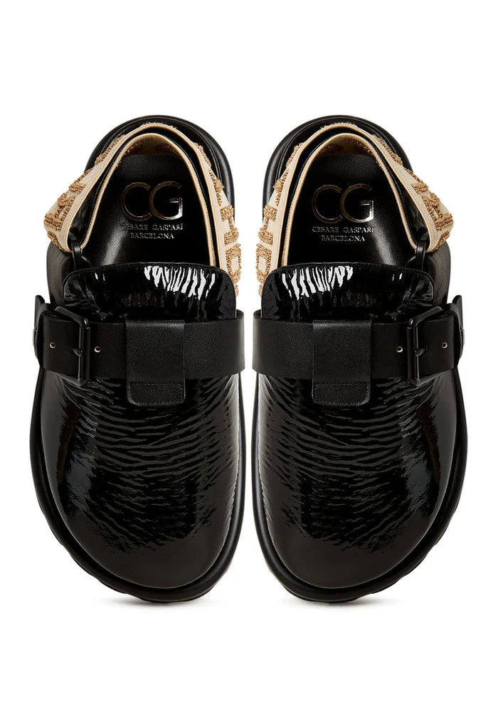 A trendy pair of black Renata platform slingback slippers for women.