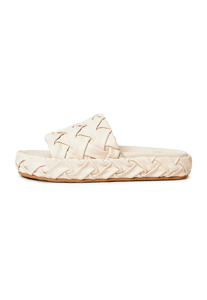 A close-up of beige platform slippers, also known as Antonella platform sandals, a trendy and stylish choice in women's platform shoes.