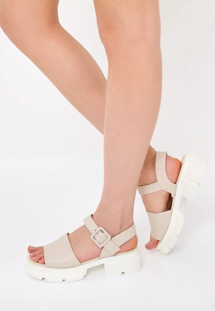 A pair of trendy chunky platform heel sandals with a thick elevated sole design for a fashion-forward look.