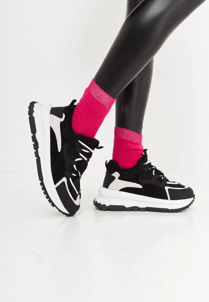 A stylish pair of trendy black platform sneakers, perfect for those looking for fashionable and warm footwear.