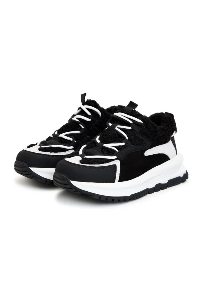 A pair of black platform sneakers, perfect for providing both comfort and style during colder seasons. These trendy fashion footwear are a must-have for any wardrobe.