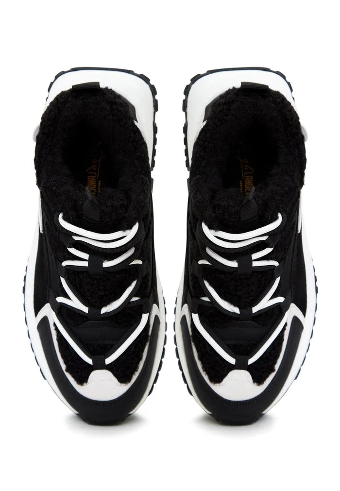 A pair of trendy black platform sneakers, perfect for warm and fashionable footwear fans.
