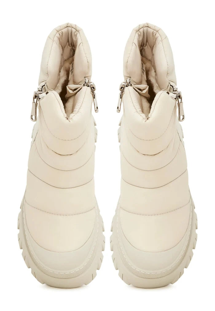 A pair of stylish beige platform boots for women, perfect as winter fashion footwear.