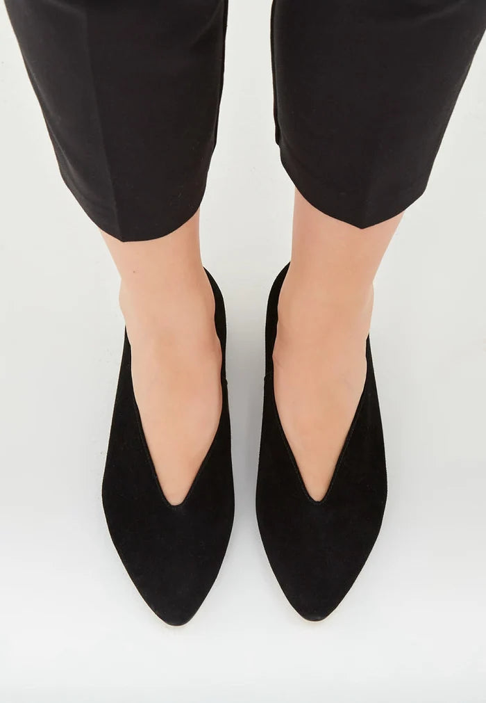 A close-up of chic black suede ballerinas, stylish pointed flats for women in leather material.