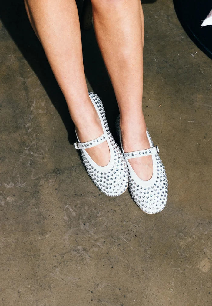 A close-up image of elegant silver leather women's rhinestone flats, perfect for adding a touch of sparkle to any outfit.