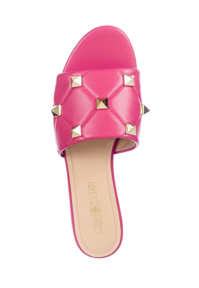 A trendy pair of designer fuchsia Rockstud sandals, also known as Mila sandals, featuring stylish studded details that add a touch of elegance to any outfit.