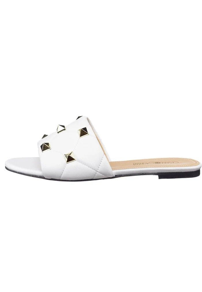 A close-up image of elegant white Rockstud and Mila sandals, perfect for a stylish summer look.