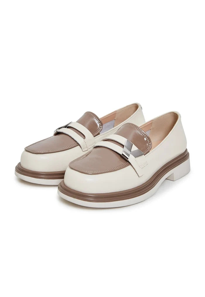 A stylish pair of women's round tip block heel loafers in beige, perfect slip-on shoes for a fashionable look.