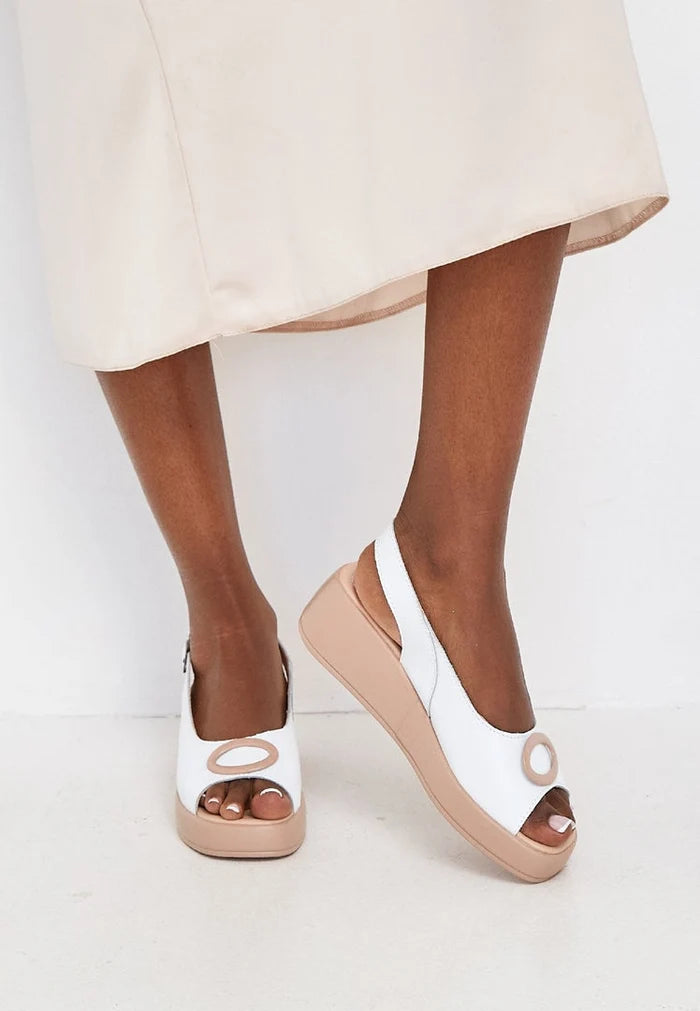 A stylish pair of white platform heel slip-on sandals for women's footwear fashion, featuring high heels for a trendy look.