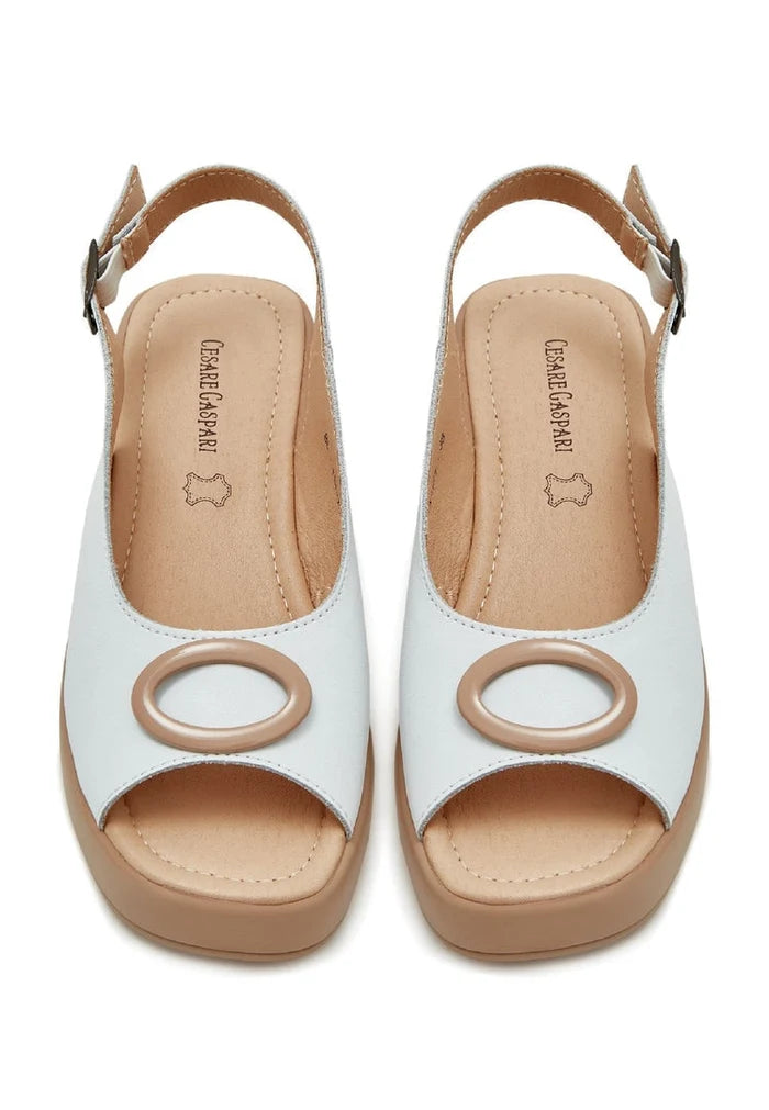 A trendy pair of white platform heel slip-on sandals, perfect for adding height and style to any outfit. Ideal for women seeking high heel sandals in their collection of chic footwear.