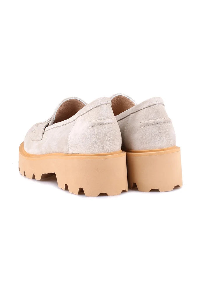 A pair of stylish beige suede slip-on loafers for men, perfect for any occasion.