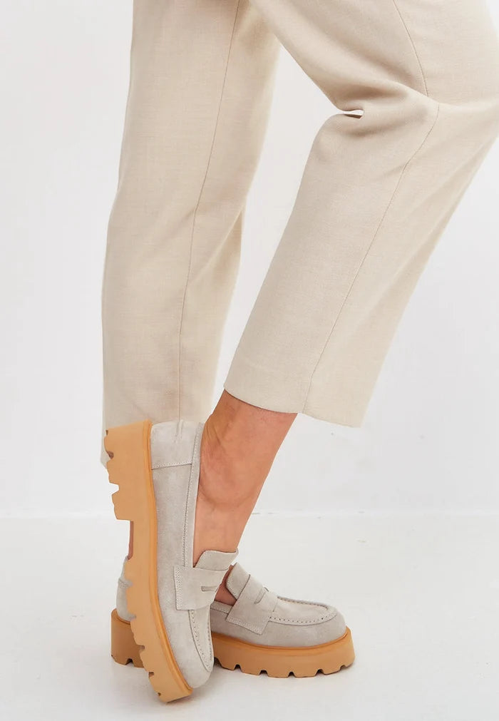 A pair of stylish slip-on suede loafers in beige, perfect for men's footwear fashion.