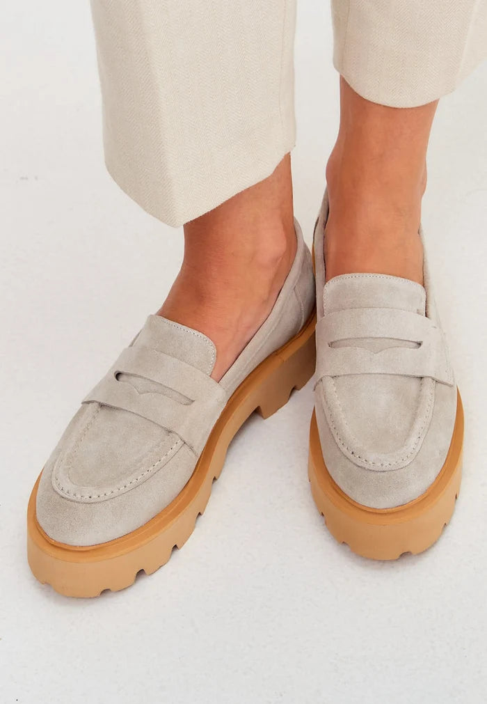 A pair of stylish slip-on suede loafers in beige, perfect for men's footwear fashion.