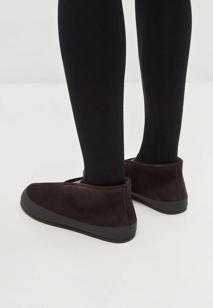 A pair of stylish brown leather slip-on Amara winter boots for women to keep your feet warm and trendy during the cold season.