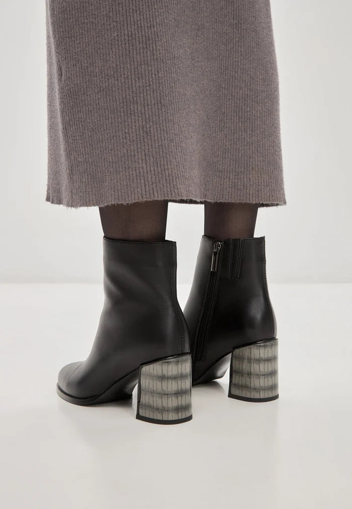 A close-up of women's black leather heel boots, featuring soft leather and a stylish design, known as the Ella boots.
