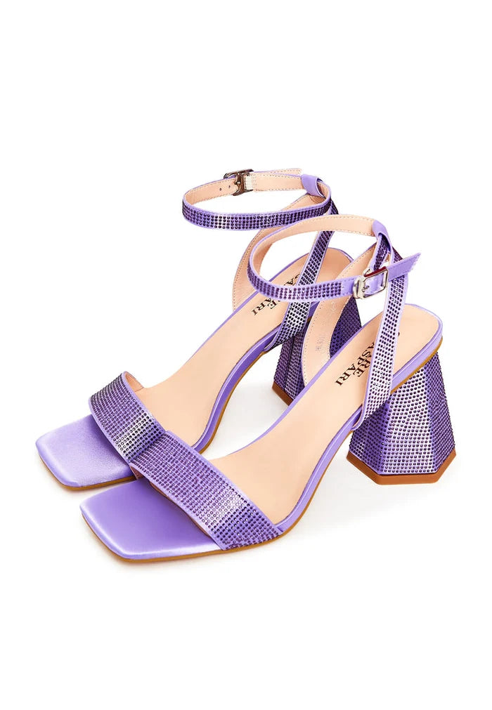 A beautiful pair of lilac strappy block heel sandals adorned with sparkling rhinestones, perfect for evenings out and formal events.