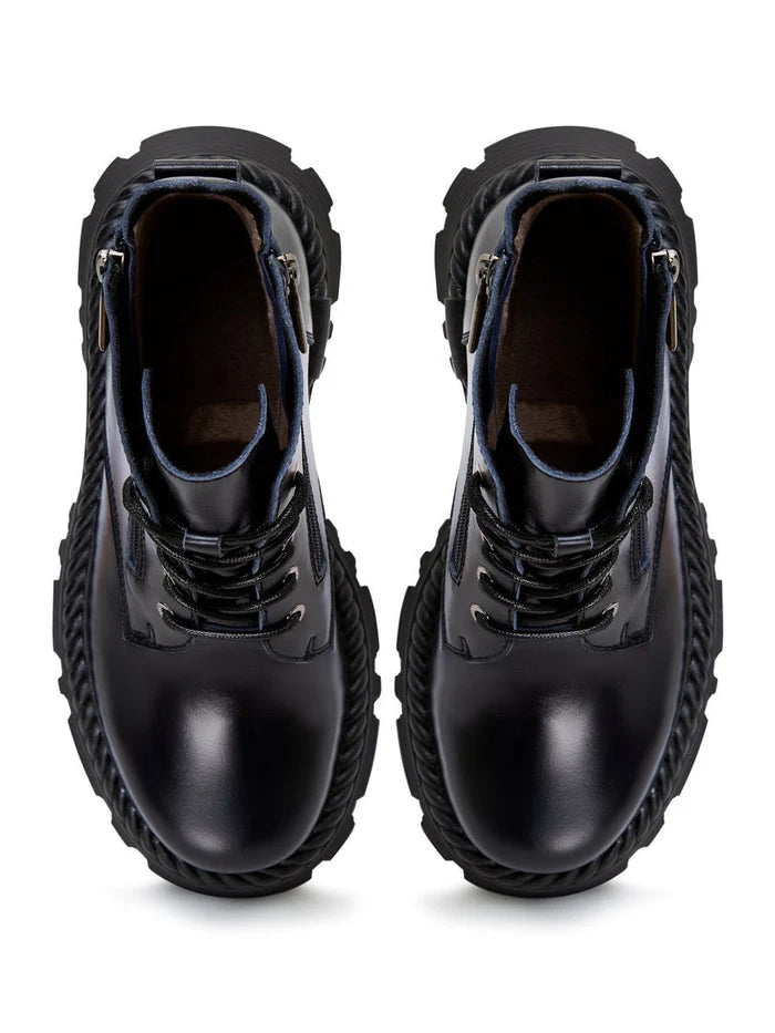 A pair of stylish lace-up ankle boots in blue, giving off a fashionable and trendy vibe.