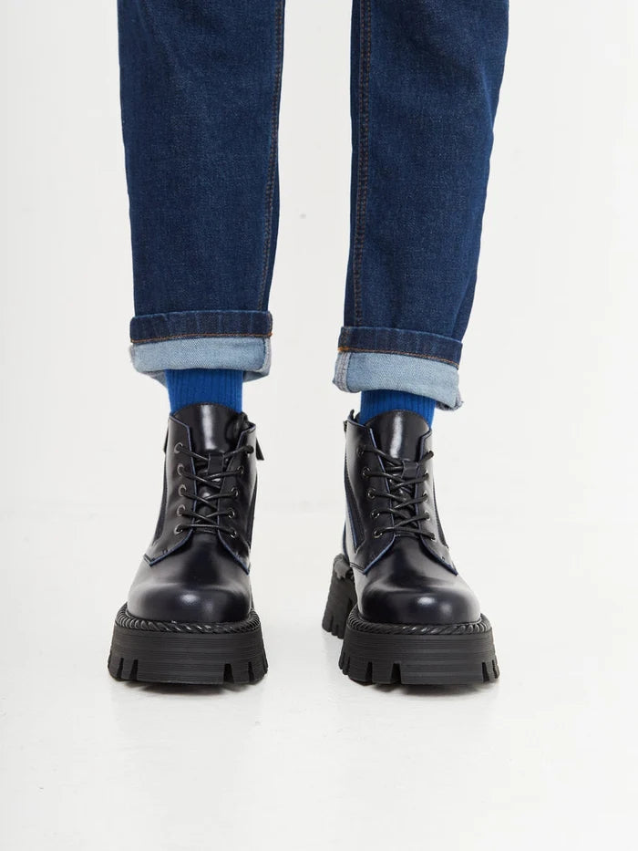 A pair of stylish lace-up ankle boots in a beautiful blue color, perfect for a fashionable look.