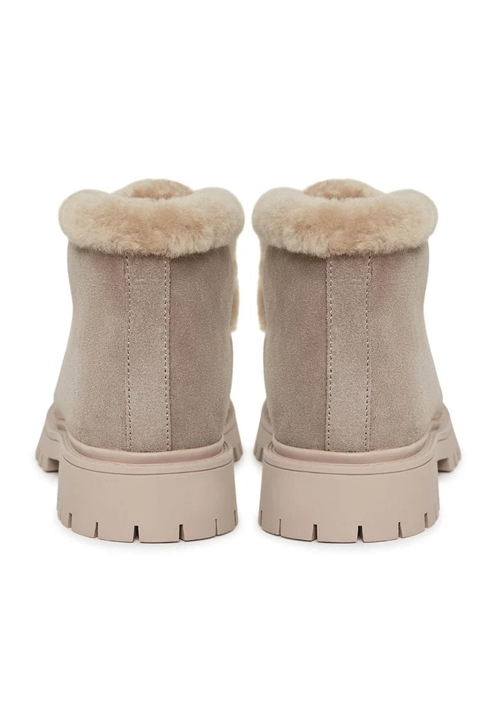 A stylish pair of women's suede ankle winter boots, perfect for staying warm and fashionable in the cold weather.