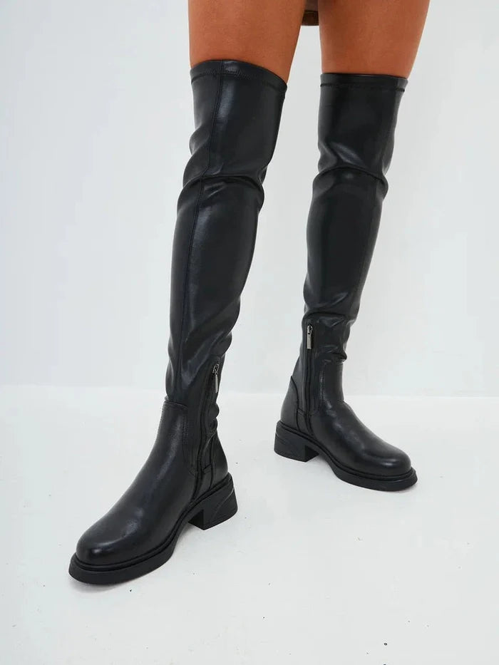 A stylish pair of over-the-knee suede boots - the epitome of chic fashion boots for women's footwear.