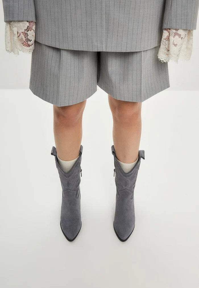 A pair of stylish women's Elena suede cowboy boots in grey, perfect for adding a trendy Western flair to any outfit.