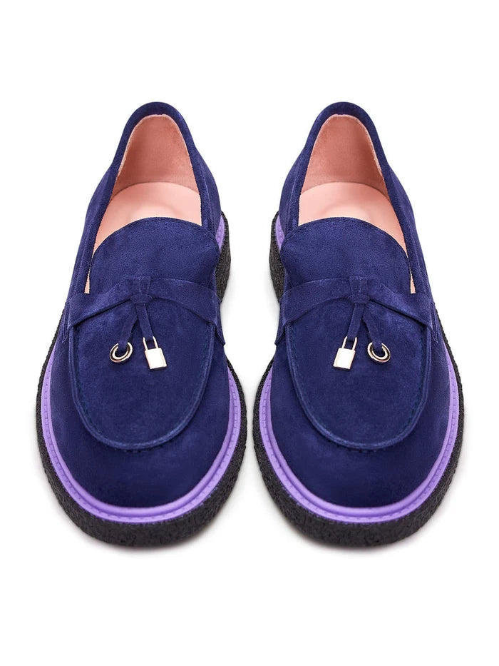 A stylish pair of men's navy blue suede slip-on loafers.