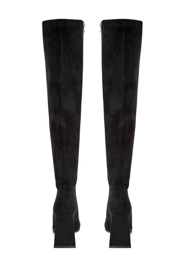 A pair of designer thigh-high boots made of high-end suede, representing luxury women's boots and premium over-the-knee boots, are exclusive suede footwear.