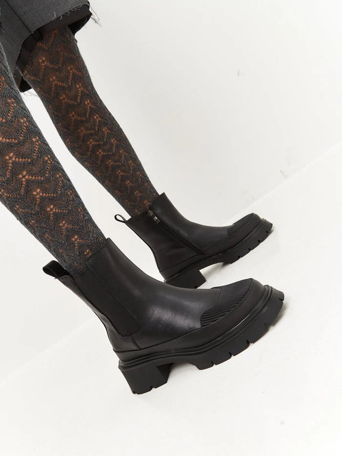A stylish pair of black urban ankle boots with a platform design, perfect for women who love fashion footwear.