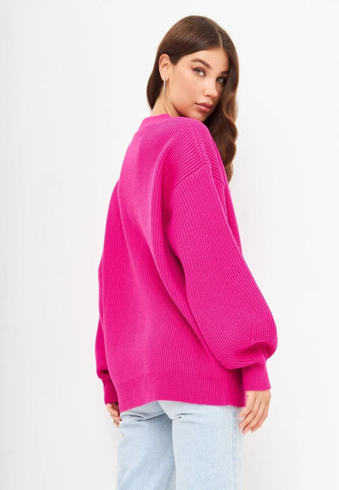A stylish pink V-neck cardigan for women, perfect for adding warmth and fashion to any outfit.