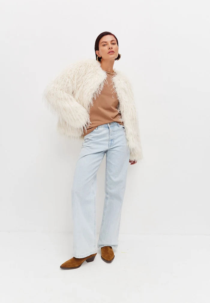 A stylish white faux fur winter jacket, perfect for cold weather outerwear and a fashionable winter coat.