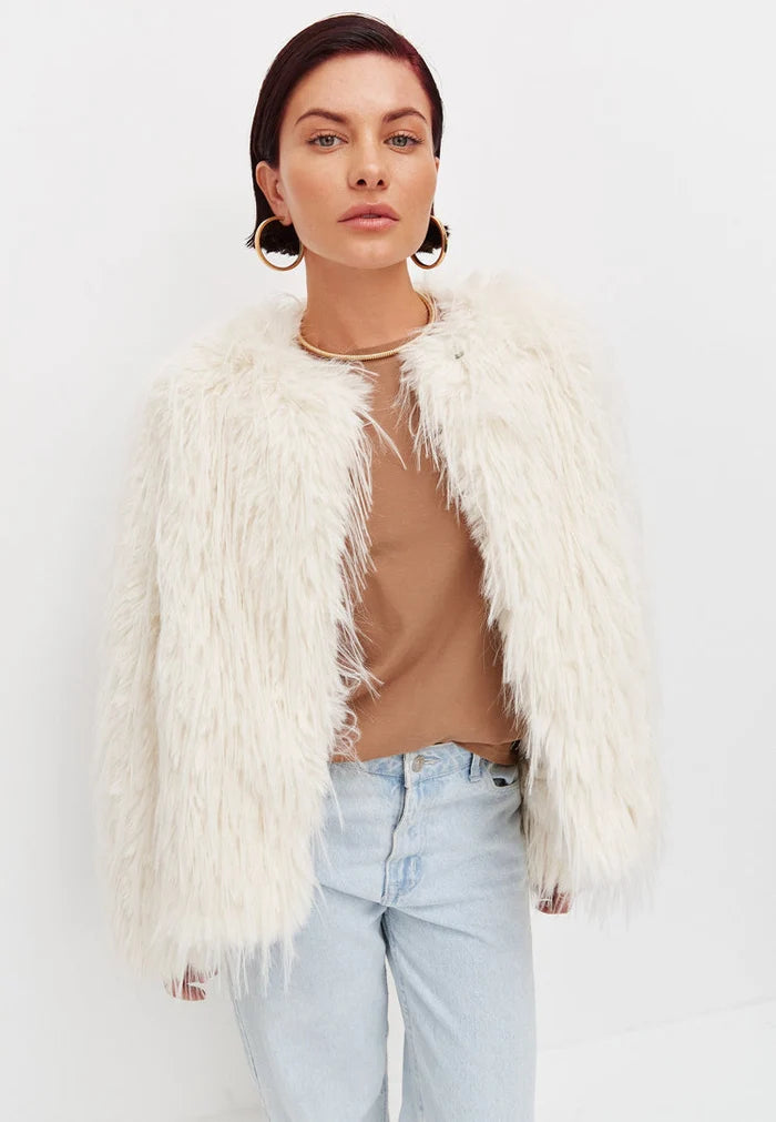 A trendy white faux fur winter jacket, perfect for cold weather outerwear that's both fashionable and cozy.