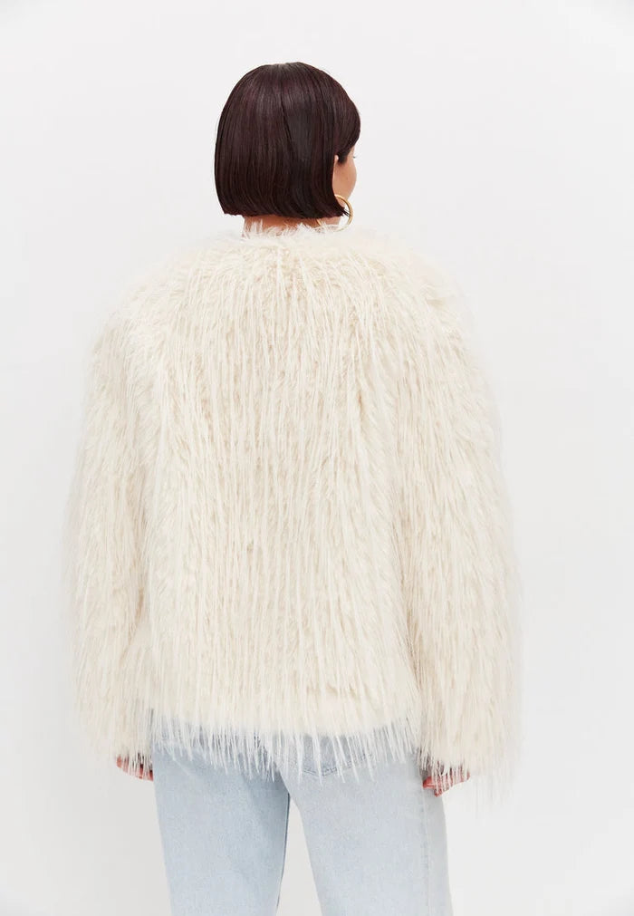 A stylish white faux fur winter jacket, perfect for cold weather outerwear, a must-have fashionable winter coat.