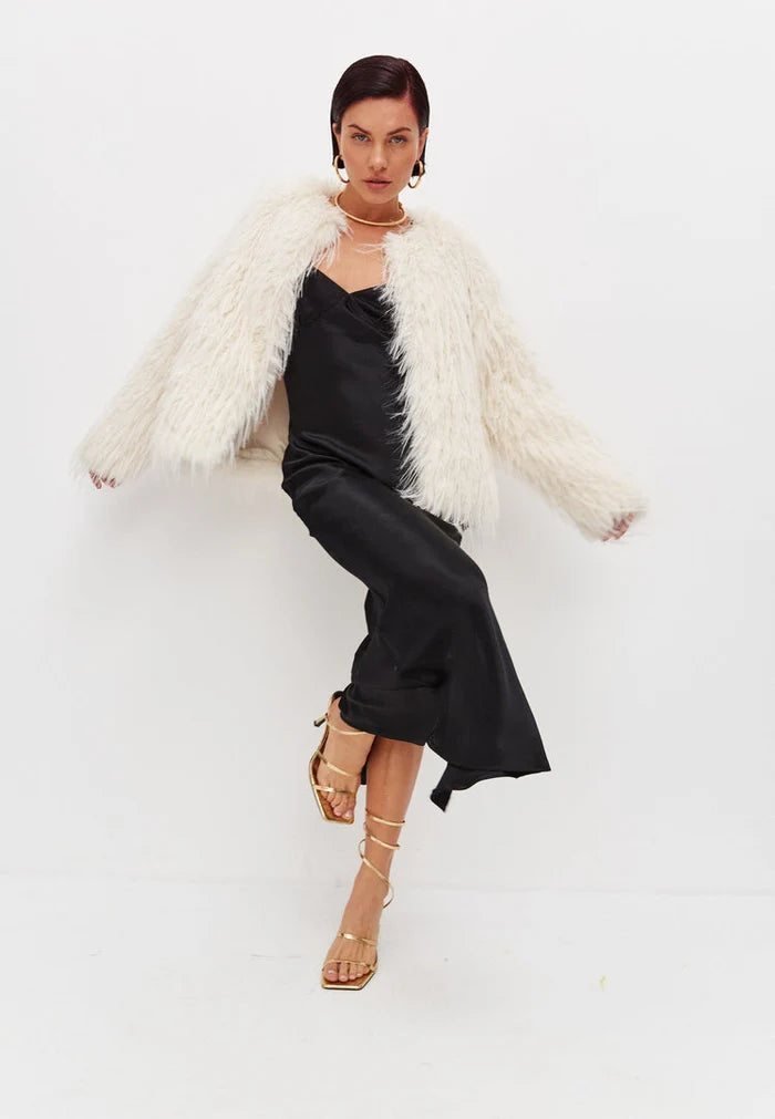 A stylish white faux fur winter jacket, perfect for cold weather, providing fashionable comfort and warmth.