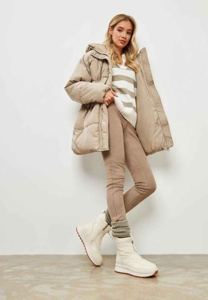 A pair of stylish ivory platform boots for women, perfect for winter fashion with a warm and cozy design.