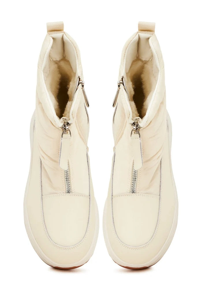 A stylish pair of ivory platform winter boots for women, perfect for keeping your feet warm and in style during the chilly season.